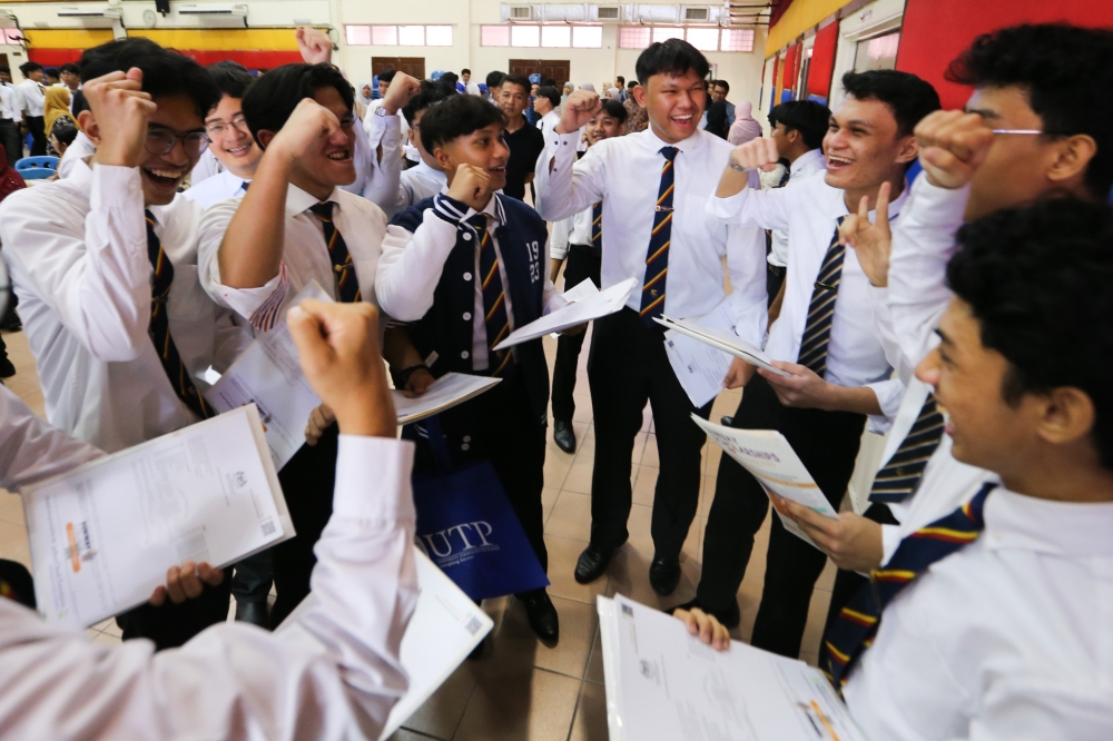 Students celebrate after receiving the results of Sijil Pelajaran Malaysia (SPM) at Sekolah Sultan Alam Shah May 27, 2024. Recently, Prime Minister Datuk Seri Anwar Ibrahim announced that all students who achieve 10As or more in the Sijil Pelajaran Malaysia (SPM) will be guaranteed a spot in the Matriculation programme, regardless of their ethnic background. — Picture by Miera Zulyana