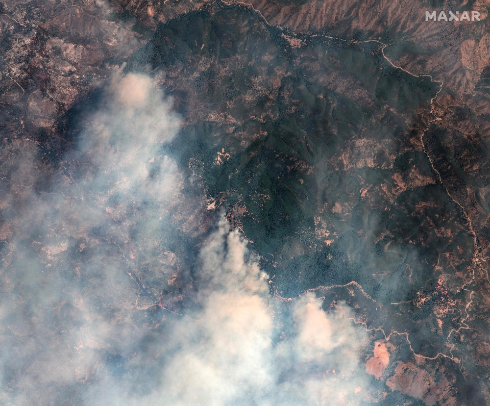 This handout satellite image released by Maxar Technologies shows smoke rising from active fire lines as the Lake Fire continues to burn in Santa Barbara County, California, on July 9. — Image from AFP