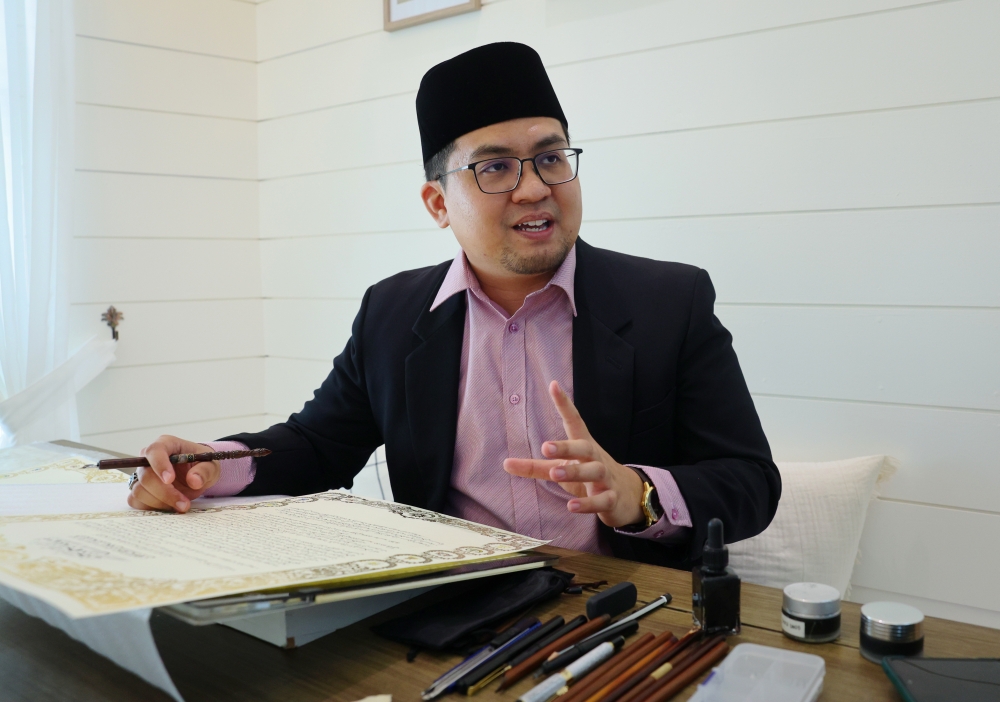 Chief coordinator of the Pahang Calligraphy Academy at Yayasan Pahang Khairi Izat Amir Mohd Izam shares his experience in producing the calligraphic text for the invitation to the King’s installation ceremony. — Bernama pic