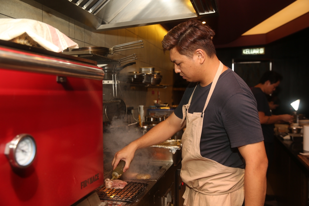 Lau working the grill at the restaurant’s new location.