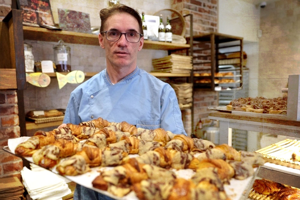 French pastry chef Stephane Louvard poses with his crookies, a croissant filled with cookie dough. ― AFP pic