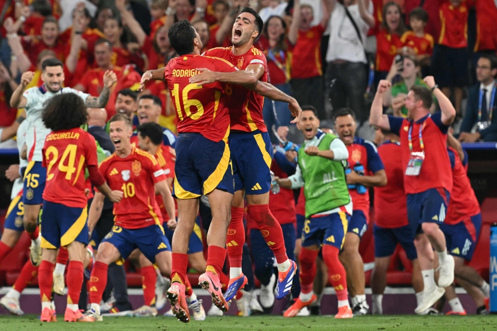 Spain’s midfielder #16 Rodri and Spain’s midfielder #06 Mikel Merino celebrate at the end of the Uefa Euro 2024 semi-final football match between Spain and France at the Munich Football Arena in Munich July 9, 2024. — AFP pic