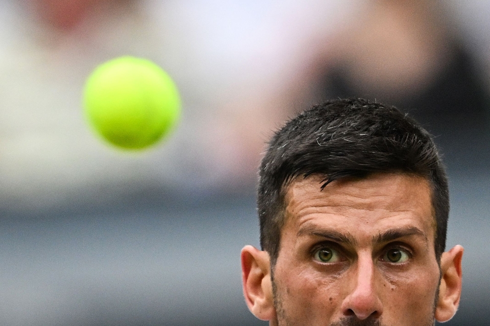 Serbia’s Novak Djokovic eyes the ball before returning against Italy’s Lorenzo Musetti during their men’s singles semi-final tennis match on the twelfth day of the 2024 Wimbledon Championships at The All England Lawn Tennis and Croquet Club in Wimbledon July 12, 2024. — AFP pic