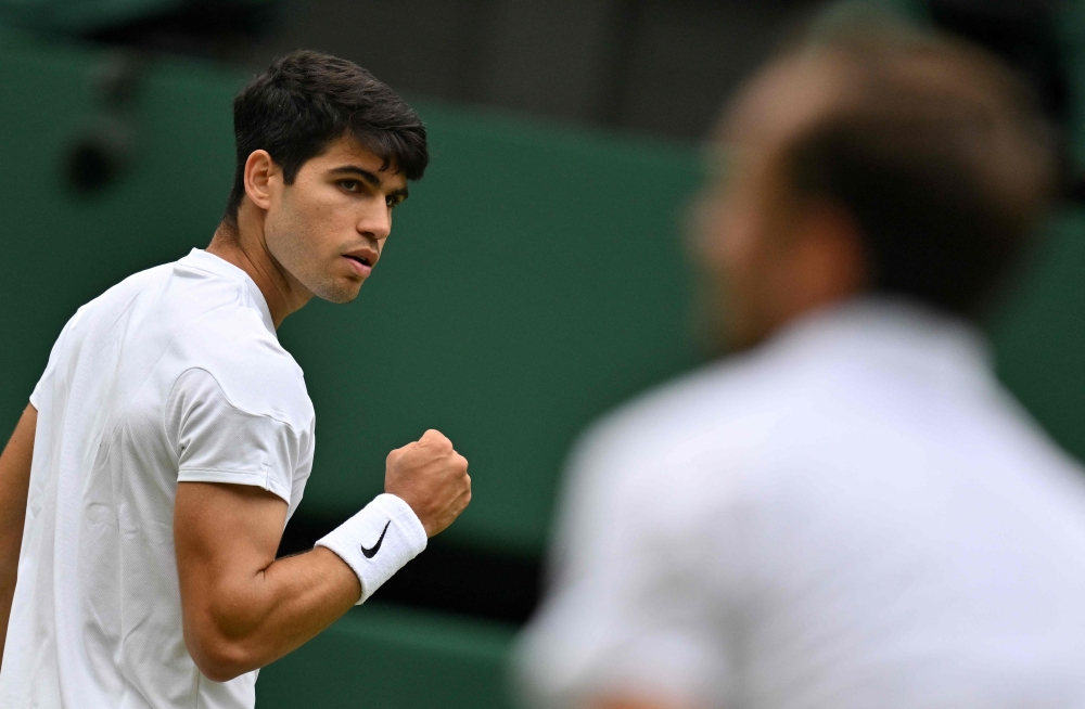 Spain’s Carlos Alcaraz returns against Russia’s Daniil Medvedev during their men’s singles semi-final tennis match on the twelfth day of the 2024 Wimbledon Championships at The All England Lawn Tennis and Croquet Club in Wimbledon July 12, 2024. — AFP pic