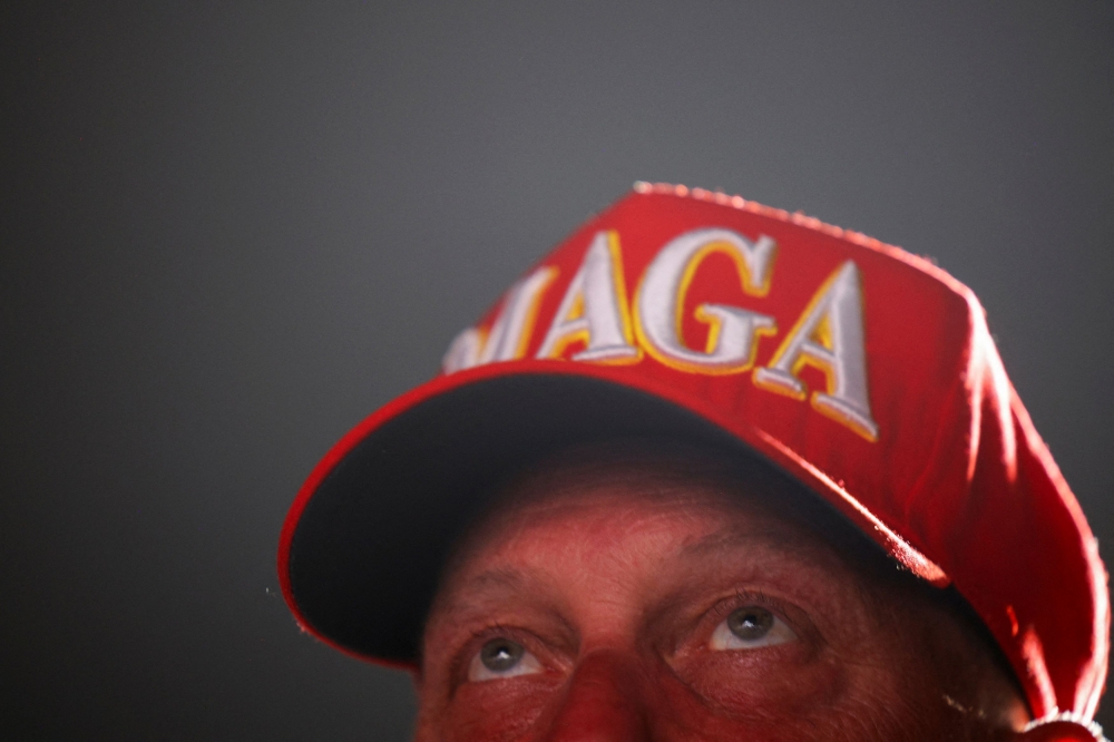 A supporter of Republican presidential candidate and former US President Donald Trump looks on during a campaign rally at Trump's golf resort in Doral, Florida July 9, 2024. — Reuters pic  