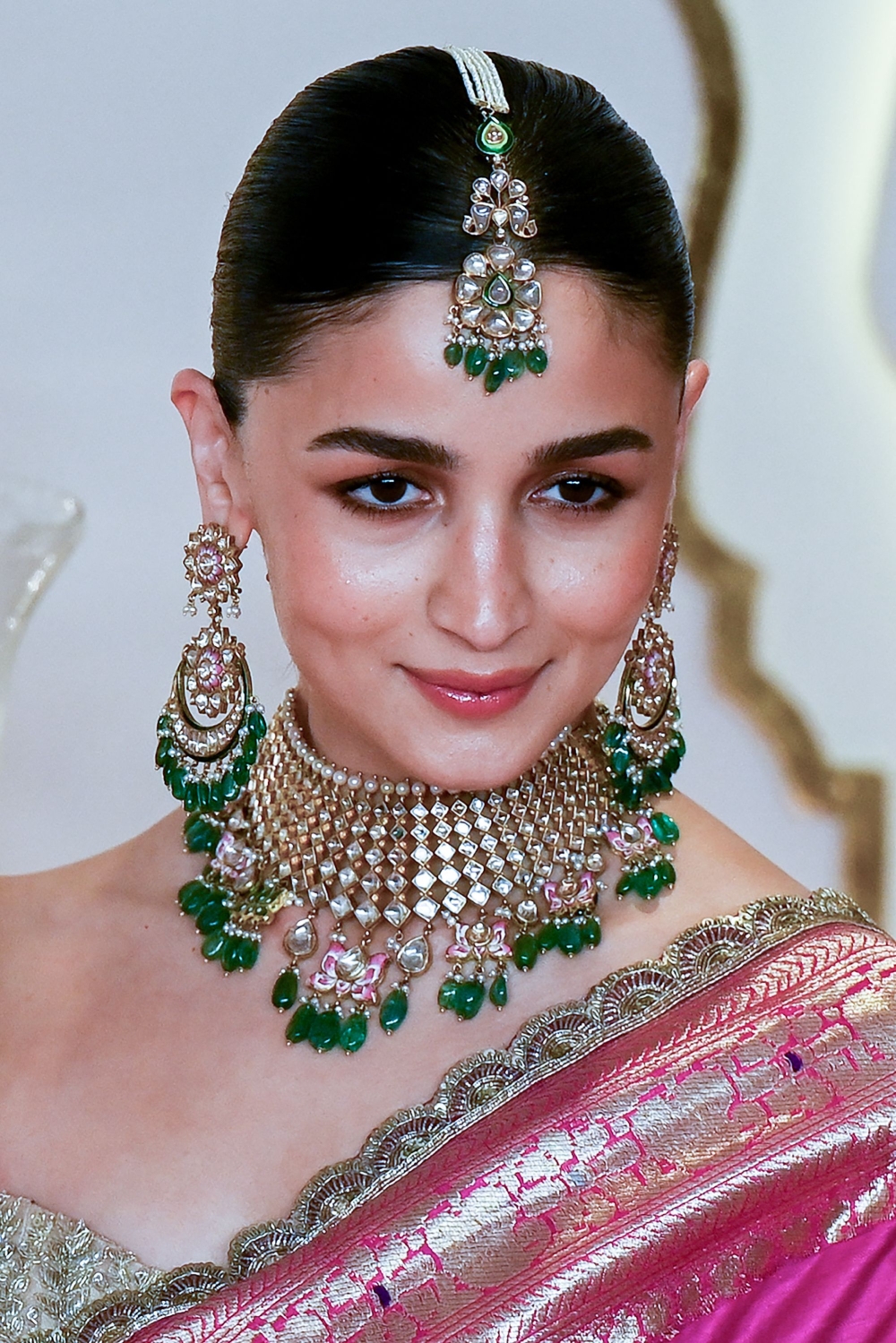 Bollywood actress Alia Bhatt poses for photos as she arrives to attend the wedding ceremony. — AFP pic