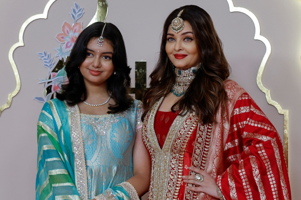 Actor Aishwarya Rai Bachchan and her daughter Aaradhya pose for pictures on the red carpet on the day of the wedding of Anant Ambani and Radhika Merchant in Mumbai, India, July 12, 2024. — Reuters pic 