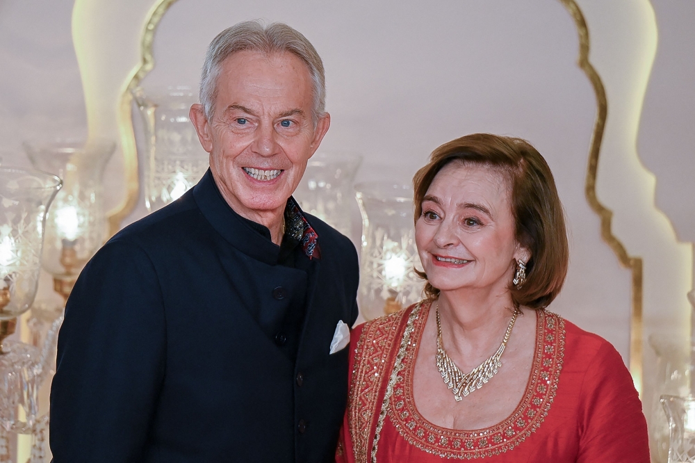 Britain’s Former Prime Minister Tony Blair with his wife Cherie pose for photos as they arrive to attend the wedding ceremony in Mumbai on July 12, 2024. — AFP pic 