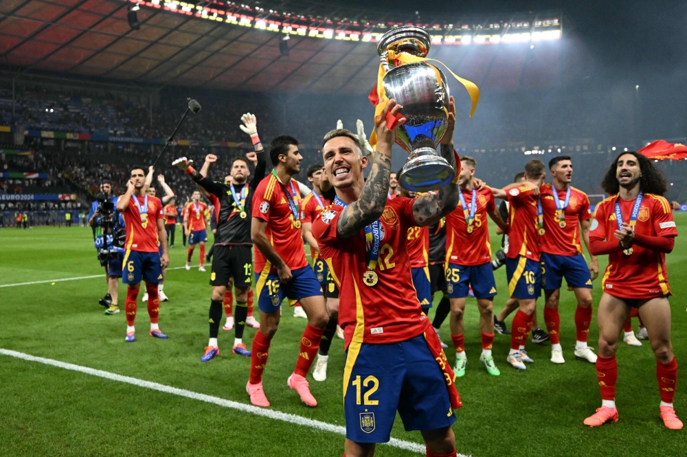 Spain’s defender #12 Alejandro Grimaldo rises the trophy during a lap of honour after winning the Uefa Euro 2024 final football match between Spain and England at the Olympiastadion in Berlin July 14, 2024. — AFP pic