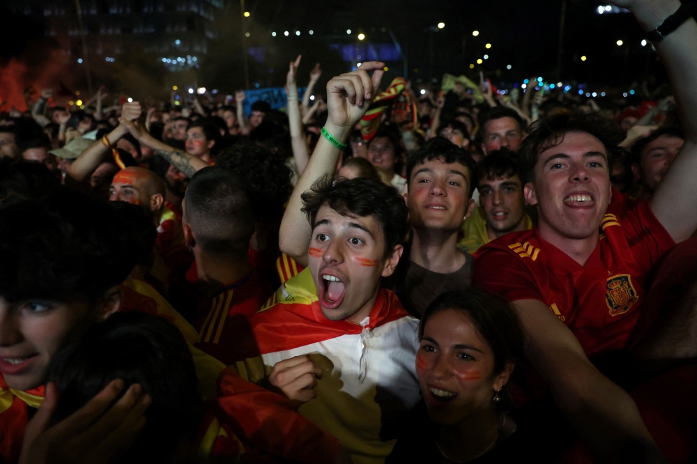 Spain fans celebrate Spain’s victory in the Uefa Euro 2024 final football match between Spain and England, in Madrid July 14, 2024. — AFP pic