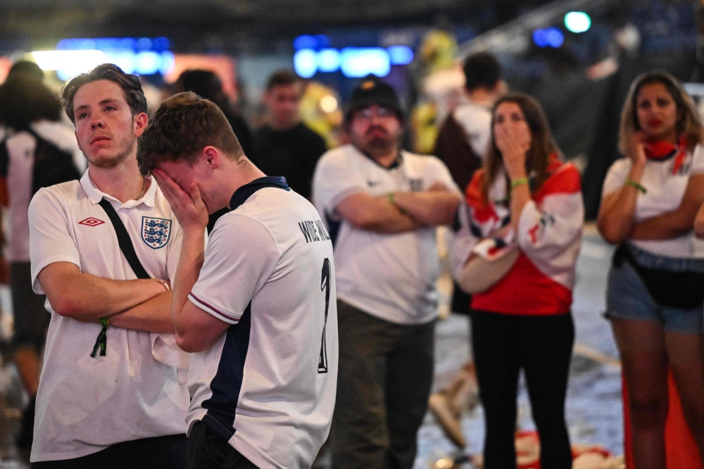 England fans react after watching the Uefa Euro 2024 final football match between Spain and England being played in Berlin, during a screening at the O2 Arena in London on July 14, 2024. — AFP pic