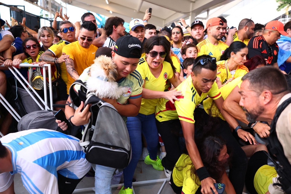 Fans storm the gates of the Hard Rock Stadium in Miami Gardens, Florida July 14, 2024, ahead of the Conmebol Copa America 2024 final between Argentina and Colombia. — AFP pic