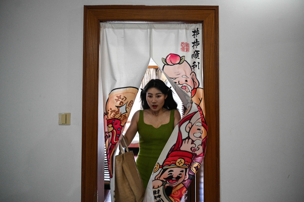 This photo taken on June 18, 2024 shows actress Guo Ting leaving her apartment to attend an audition in Hengdian in east China's Zhejiang Province. — AFP pic