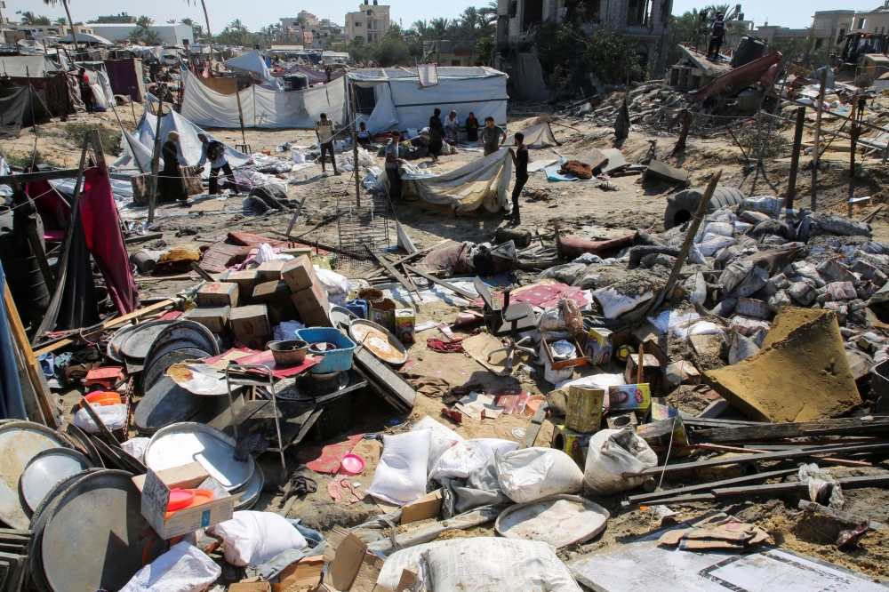 Palestinians inspect the damage following an Israeli strike at a tent camp in Al-Mawasi area, amid Israel-Hamas conflict, in Khan Younis in the southern Gaza Strip July 13, 2024. — Reuters pic  