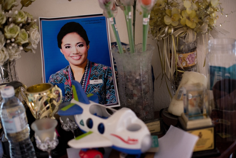 A photograph of MH17 flight chief attendant Azrina Yakob is placed on a table at her home in Sungai Pelek, Selangor. A 10th-year memorial is being observed this week for those on board who died on July 17, 2014 when the Malaysia Airlines plane was downed over Ukraine. — AFP pic