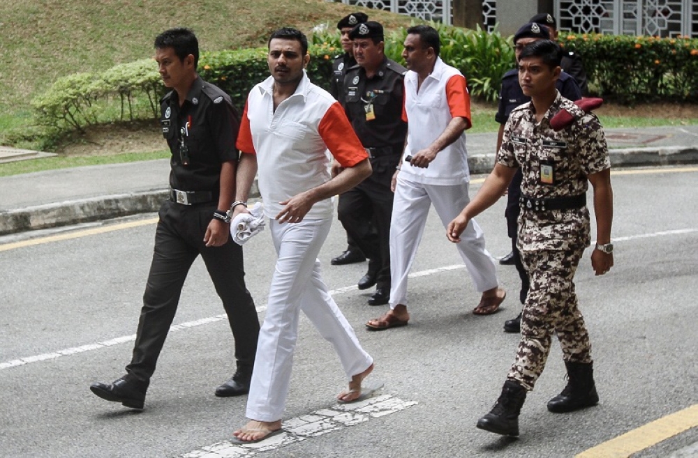 File picture shows N. Pathmanabhan (second from right) and T. Thilaiyalagan (second from left) being led to the Federal Court in Putrajaya March 16, 2017. — Bernama pic