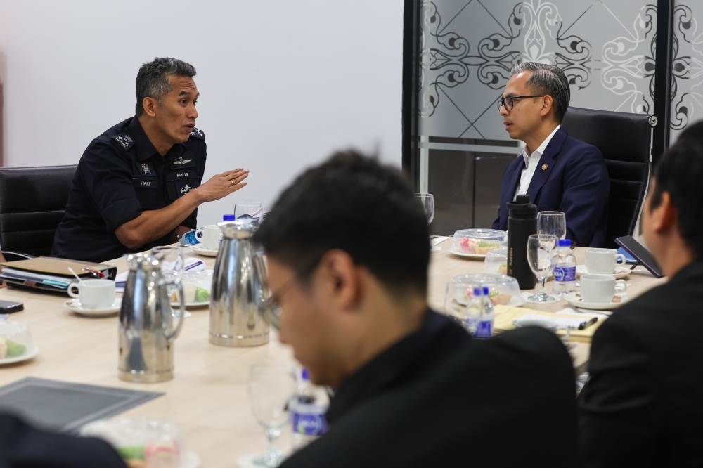 Communications Minister Fahmi Fadzil and Bukit Aman Criminal Investigation Department director Datuk Seri Mohd Shuhaily Mohd Zain in a meeting, July 18, 2024. — Picture from X/Fahmi Fadzil 