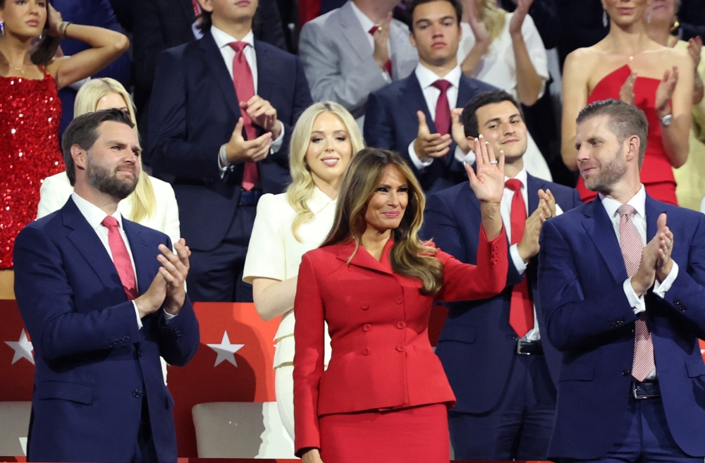 Former first lady Melania Trump waves as she is flanked by vice presidential nominee Senator JD Vance (R-OH) and Donald Trump Jr., as Republican presidential nominee and former US President Donald Trump speaks on Day 4 of the Republican National Convention (RNC), at the Fiserv Forum in Milwaukee, Wisconsin July 18, 2024. — Reuters pic  