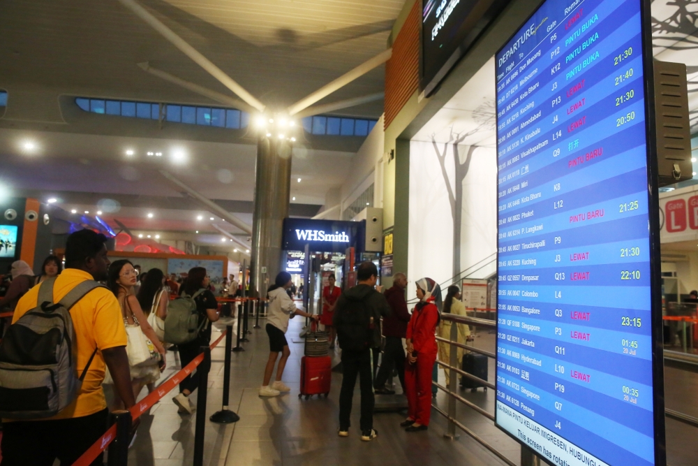 KLIA's Terminal 2 hit by global IT system outage resulting in long lines at check-in counters and flight delays, as shown in the flight display system. July 19 , 2024. — Picture by Choo Choo May.