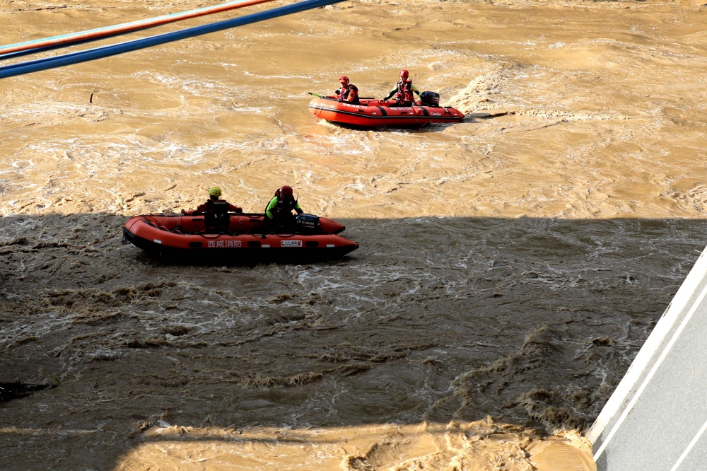 Rescuers search for survivors after a bridge collapse in the city of Shangluo. — AFP pic