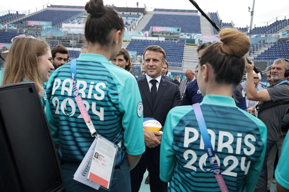 French President Emmanuel Macron speaks to athletes during his visit to 'Stade Tour Eiffel' ahead of the 2024 Olympic and Paralympic Games, in Champs de Mars in Paris, France, 24 July 2024. — Christophe Petit Tesson/Pool pic via Reuters 