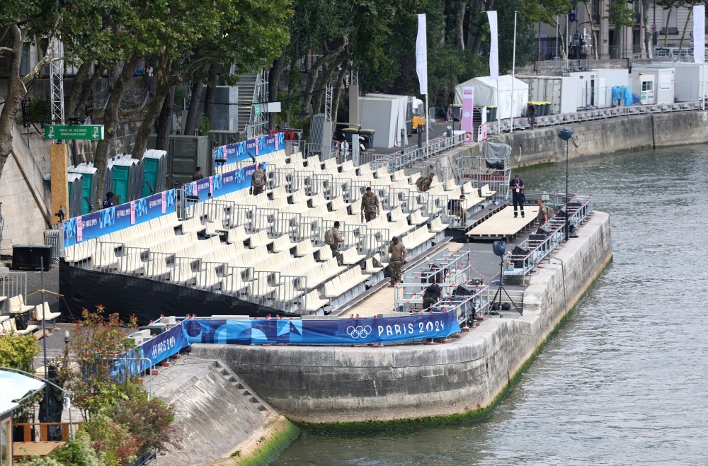 Members of military check the stand near the Seine river ahead of the Paris 2024 Olympics in Paris July 24, 2024— Reuters pic  