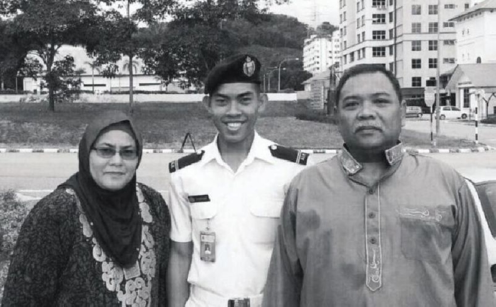 Zulfarhan poses in full ceremonial uniform with his parents at the campus of Universiti Pertahanan Nasional Malaysia. — Picture courtesy of Zulkarnain Idros