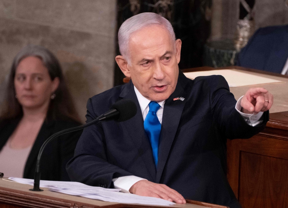 Israeli Prime Minister Benjamin Netanyahu slammed Gaza ceasefire demonstrators yesterday and called for a global alliance against the Iranian regime he accuses of funding them, as he addressed a US Congress divided by the war. — AFP pic