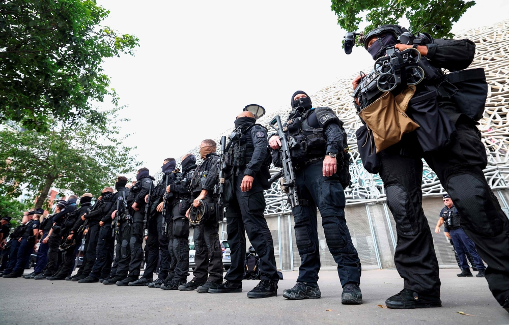 Police stand guard at the stadium before the start of the match between Israel and Mali. — AFP pic