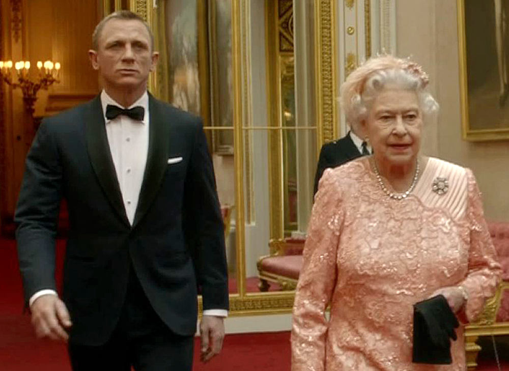 This file television screengrab image taken on July 29, 2012, shows footage featured during the Opening Ceremony of the London 2012 Olympic Games starring British actor Daniel Craig playing James Bond escorting Britain's Queen Elizabeth II through the corridors of Buckingham Palace. — AFP pic