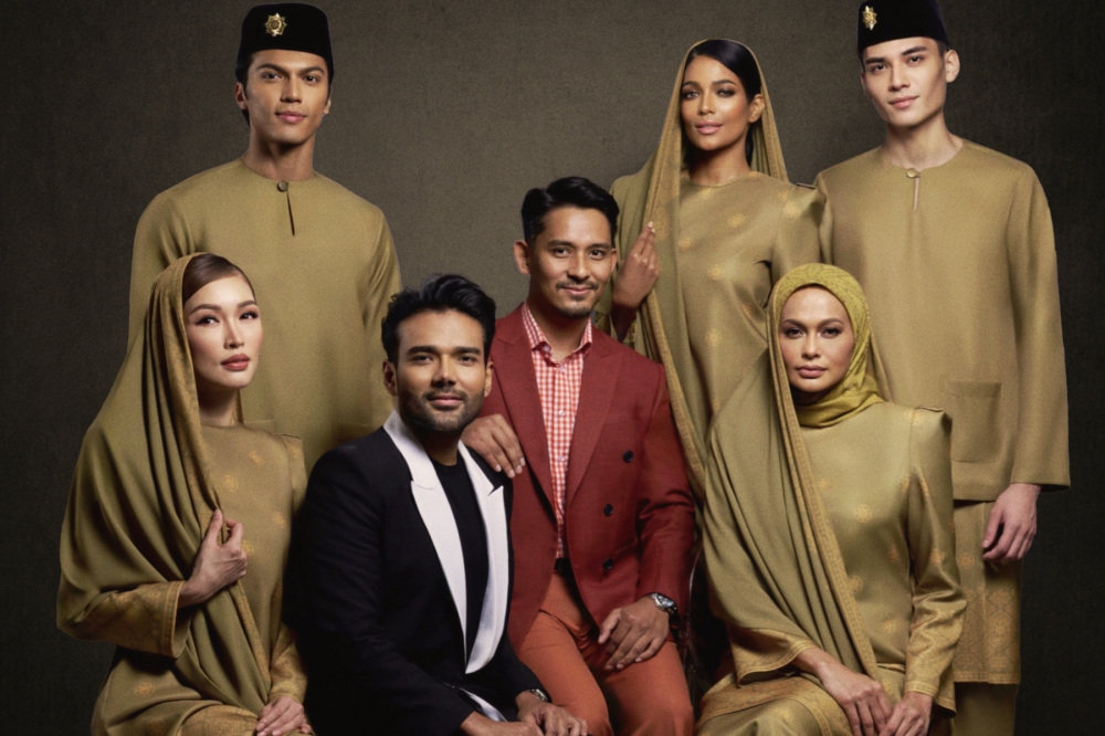 Fashion duo Rizman Nordin and Ruzaini Jamil pose with models in the collection to be worn by Malaysia's contingent at the opening ceremony of the 2024 Olympic Games. — Picture by Rizman Ruzaini