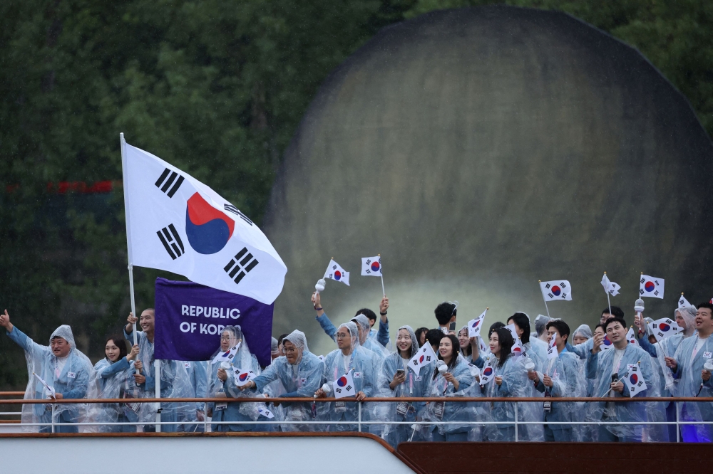 Athletes of South Korea aboard a boat in the floating parade on the river Seine during the opening ceremony in Paris, July 26, 2024. The International Olympic Committee apologised Saturday for a gaffe during the opening ceremony of the Paris Olympics in which South Korean athletes were incorrectly introduced as North Korean. — Reuters pic 