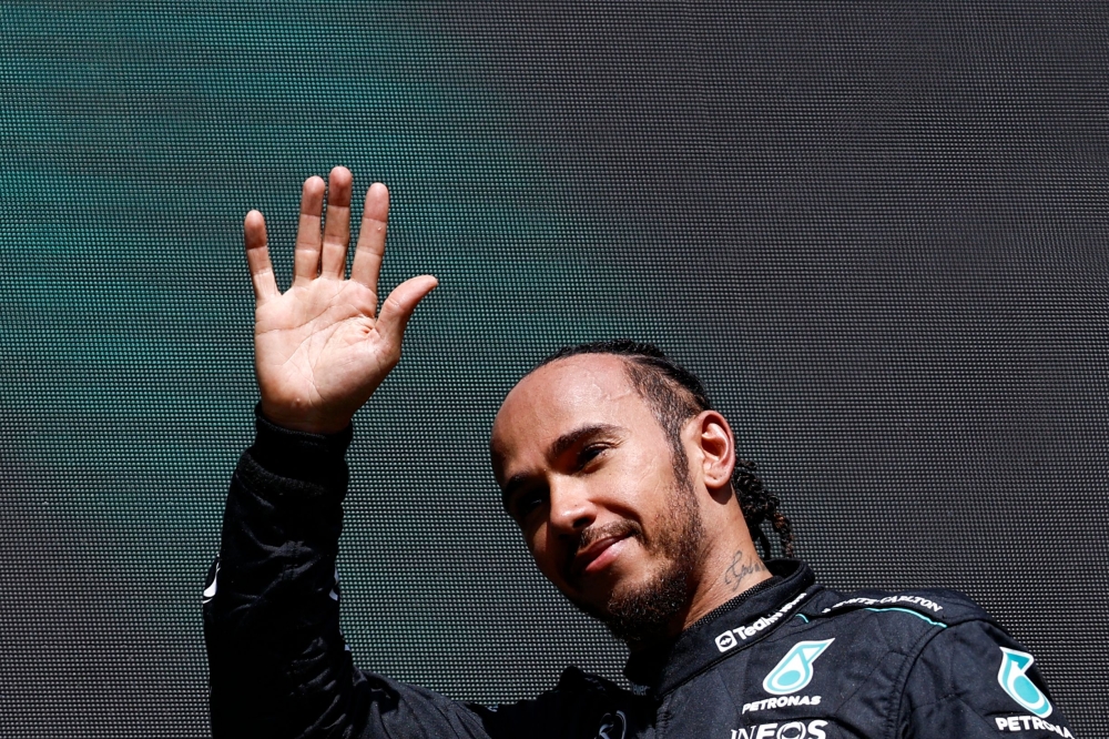 Mercedes' British driver Lewis Hamilton waves as he arrives for the podium ceremony after the Formula One Belgian Grand Prix. — AFP pic