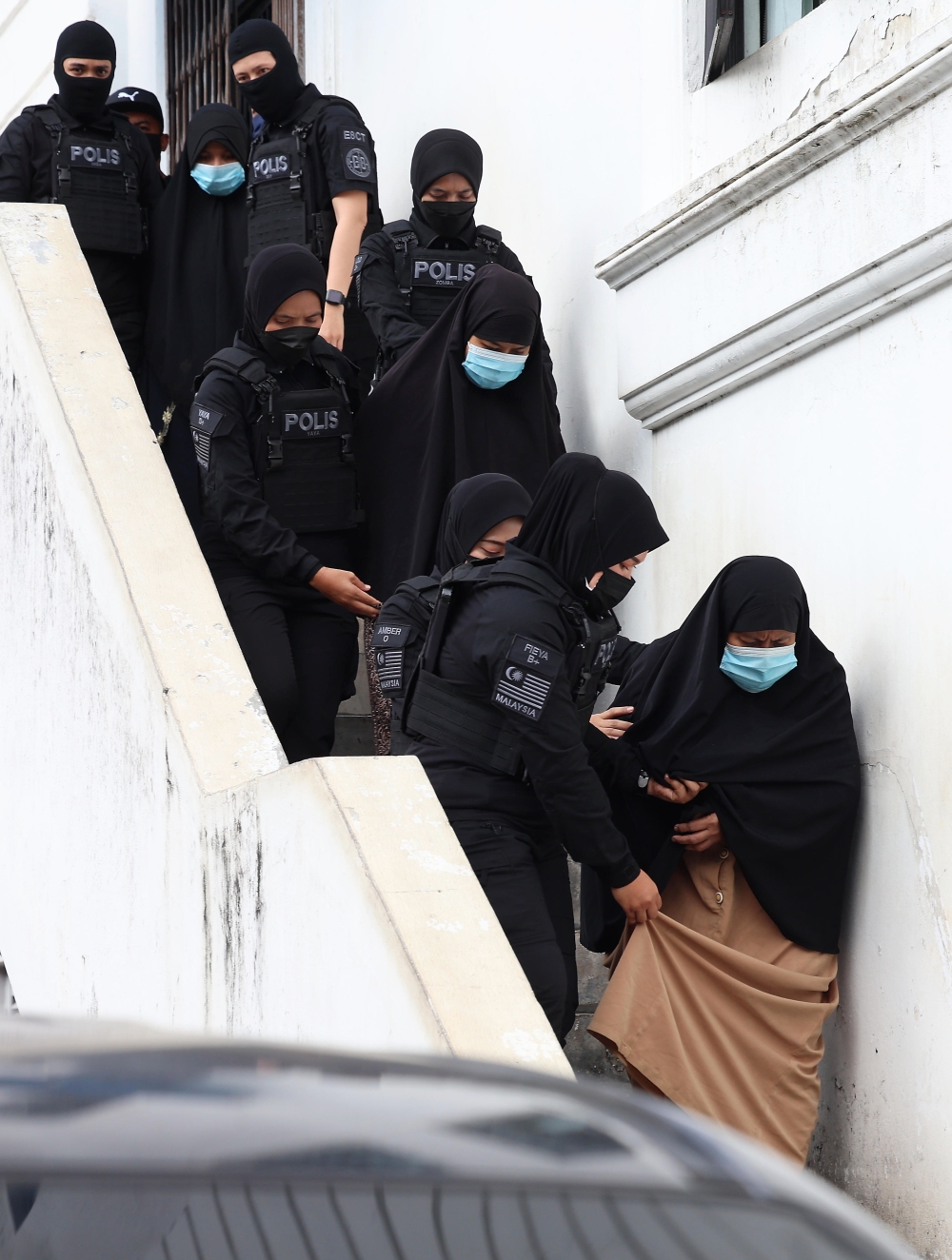 On June 19, Radin Imran Radin Mohd Yassin, 62, Radin Romyullah Radin Imran, 34, Rosna Jantan (front), 59, Farhah Sobrina Radin Imran (back), 23, and Mariah Radin Imran (centre), 19, were charged in the Sessions Court on terrorism-related charges. — Bernama pic 