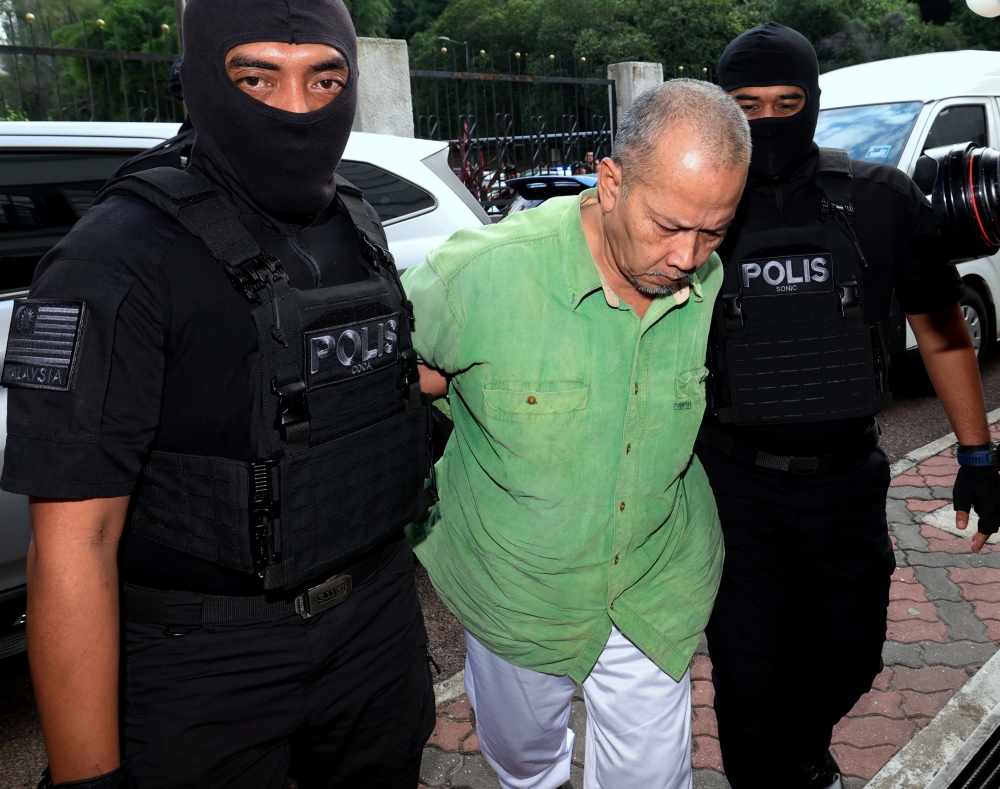 Radin Imran Radin Mohd Yassin, 62, (centre) at the Sessions Court in Johor Baru, July 31, 2024. — Bernama pic 