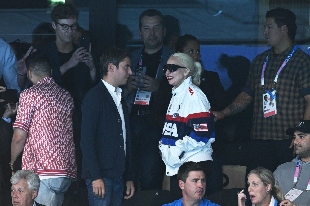 US singer and actress Lady Gaga and France's Prime Minister Gabriel Attal at a swim event at the Paris La Defense Arena in Nanterre. — AFP pic