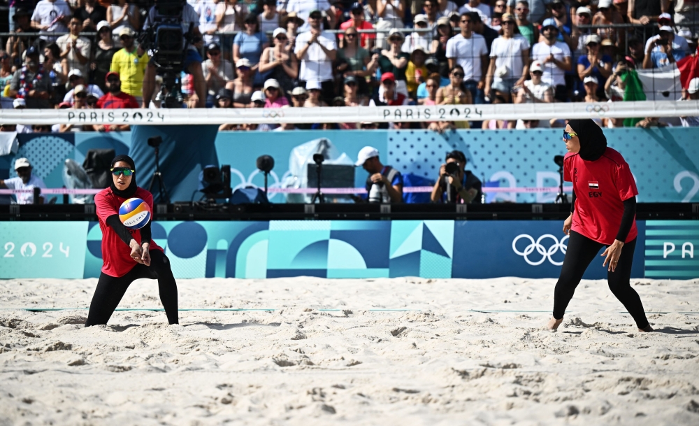 Marwa Abdelhady in action while Doaa Elghobashy looks on during the game. — Reuters pic