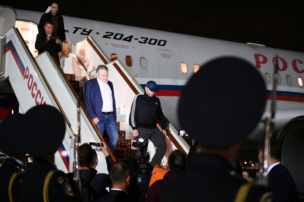 Vadim Krasikov and other Russian nationals, who were released in a prisoner exchange between Russia with Western countries, disembark from a plane during a welcoming ceremony at Vnukovo International Airport in Moscow August 1, 2024. — Sputnik/Mikhail Voskresensky/Pool pic via Reuters  