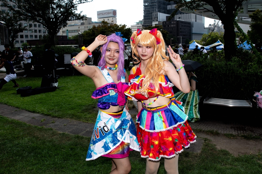 Cosplay fans pose for photos outside the World Cosplay Summit in Nagoya August 3, 2024. — AFP pic