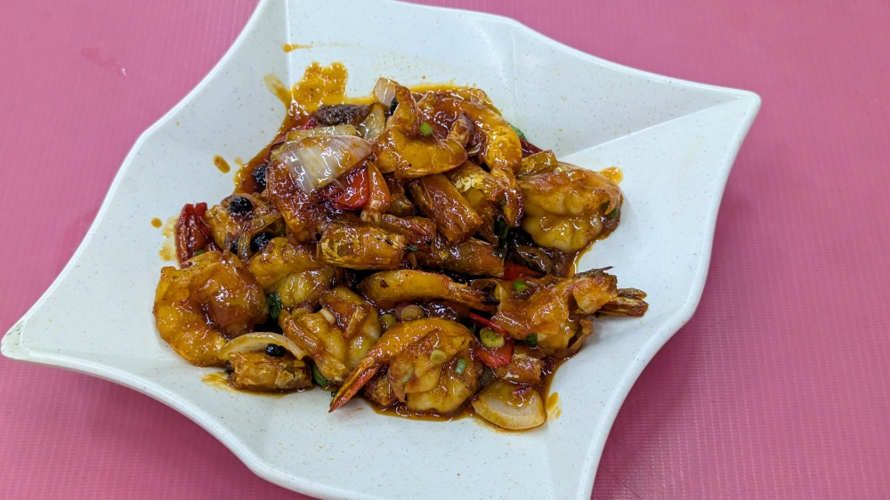 An off-menu surprise, the ‘cheong bao’ prawns were covered in a tangy, slow-burning sauce that’s neutralised with black beans. — Picture by Ethan Lau