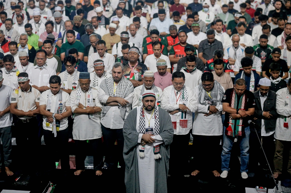 People perform prayers at the Palestine Liberation Rally held at Axiata Arena in Kuala Lumpur on Aug 4, 2024. — Picture by Sayuti Zainudin