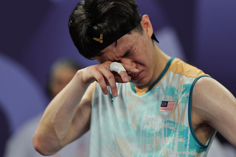 Lee Zii Jia wipes away tears after winning bronze in the match against Lakshya Sen of India at Porte de La Chapelle Arena, Paris, August 5, 2024. — Reuters pic 