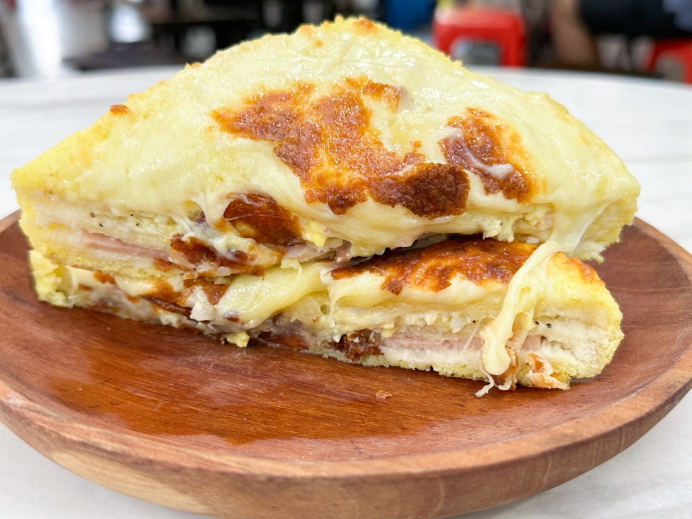 Oozy cheese sauce with layers of ham and surimi mayonnaise between pillow soft bread is a sinful treat, best paired with a hot cup of coffee. — Picture by Lee Khang Yi