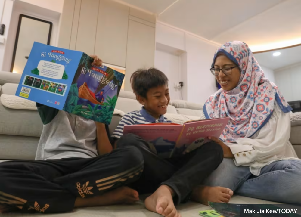 Secondary school Malay language teacher Nur Asyikin Naser reading storybooks in Malay with her children. — TODAY pic