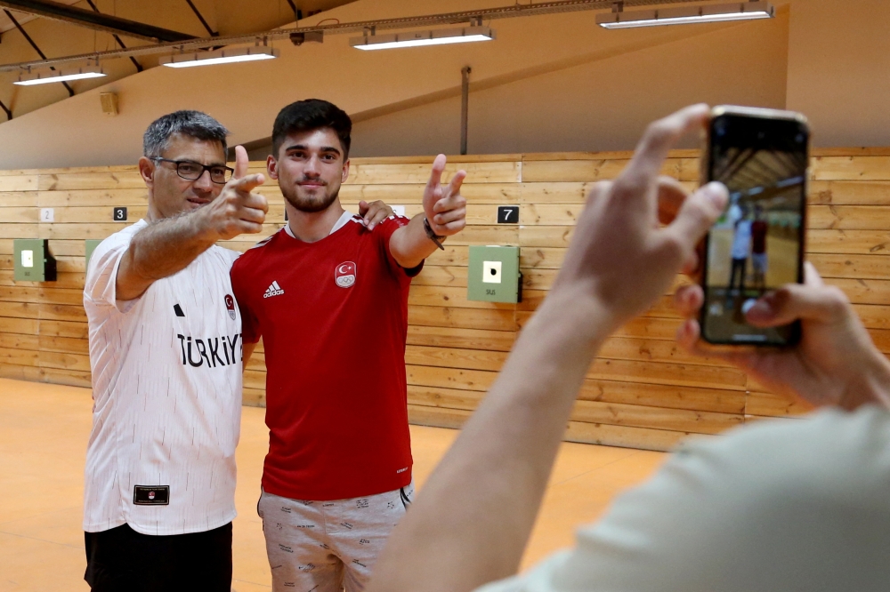 Yusuf posing with a fan after a training session in Ankara. — Reuters pic