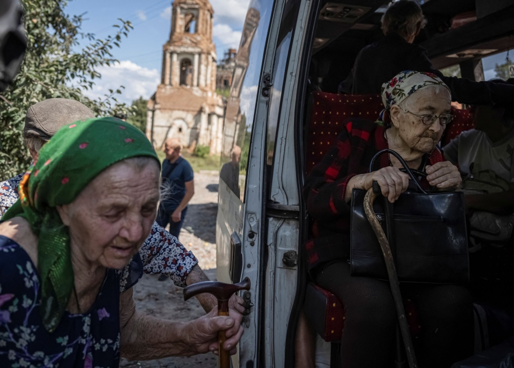 Local residents from a village near the Russian border board a bus during an evacuation to Sumy due to Russian shelling, amid Russia's attack on Ukraine, in Sumy region, Ukraine August 9, 2024. — Reuters pic