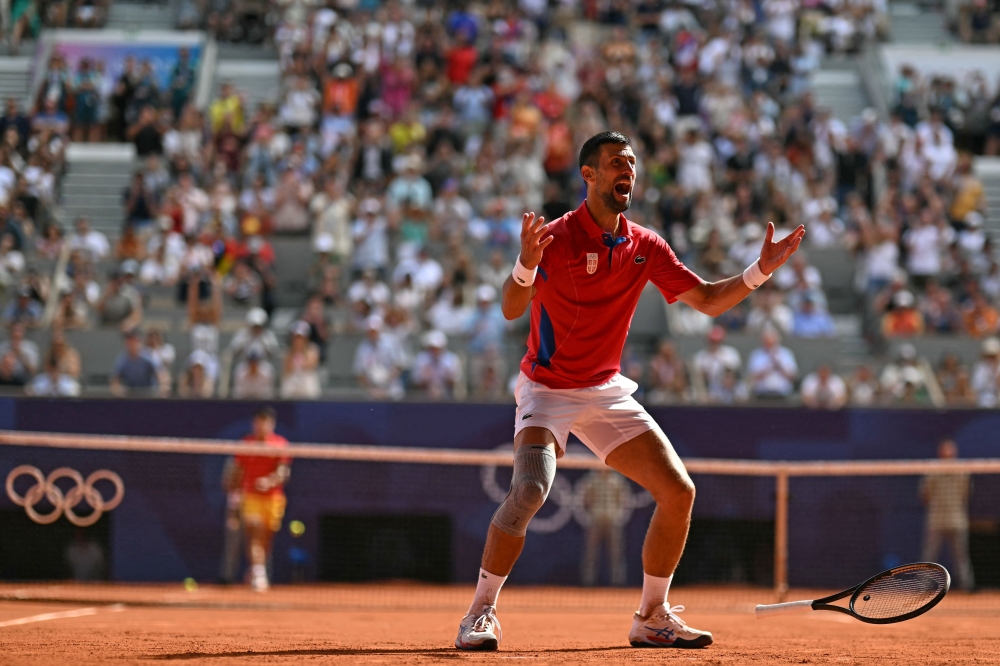 Novak Djokovic stunned Carlos Alcaraz in a memorable men’s final to clinch tennis gold and become only the fifth player to complete the Golden Slam of all four majors plus Olympic gold. — AFP pic