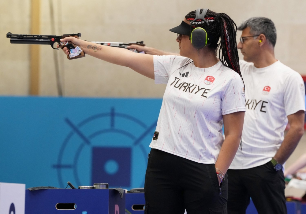 Yusuf Dikec and Sevval Ilayda Tarhan in action during the 10m air pistol mixed team event. — Reuters pic