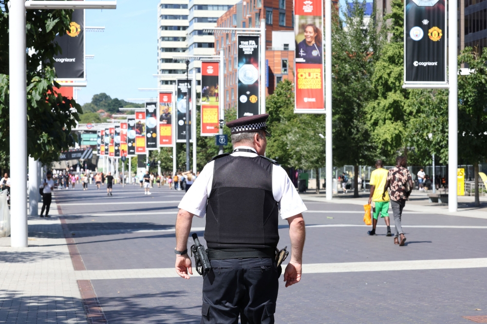 A police officer is seen by Wembley stadium, ahead of Taylor Swift's first live performance since her concerts in Vienna were cancelled after a security threat was uncovered, in Wembley, London August 13, 2024. — Reuters pic  