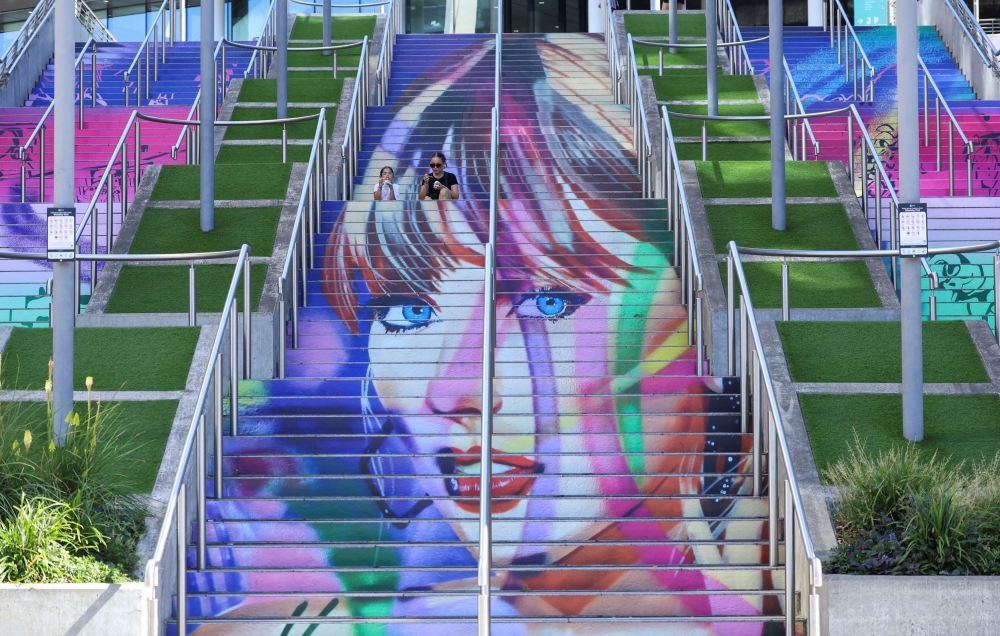 Louise Kent and her niece Amelia Defontaine, 9, eat ice cream on the ‘Swiftie Steps’ at Wembley Stadium, in London August 13, 2024. — Reuters pic  